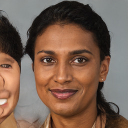 Joyful black adult female with medium  brown hair and brown eyes