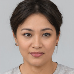 Joyful asian young-adult female with medium  brown hair and brown eyes