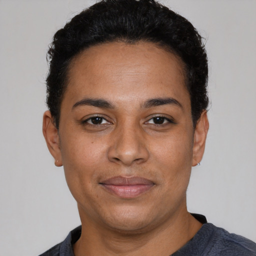 Joyful latino adult female with short  black hair and brown eyes