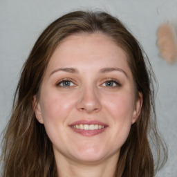 Joyful white young-adult female with long  brown hair and blue eyes