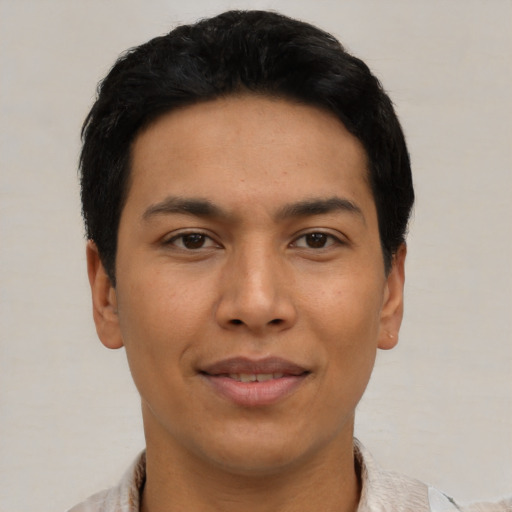 Joyful asian young-adult male with short  black hair and brown eyes