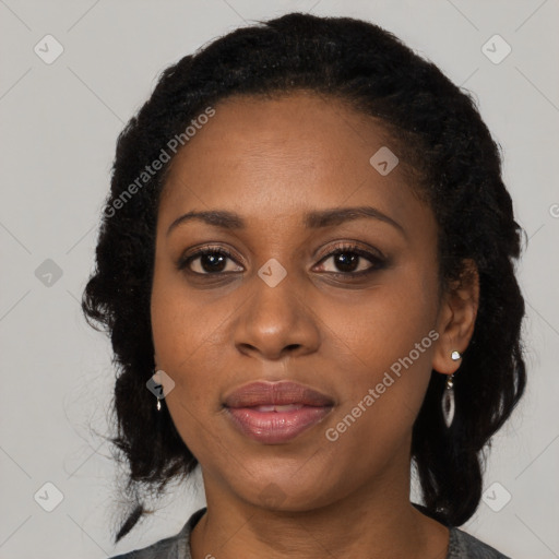 Joyful black adult female with medium  black hair and brown eyes