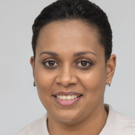 Joyful black adult female with short  black hair and brown eyes