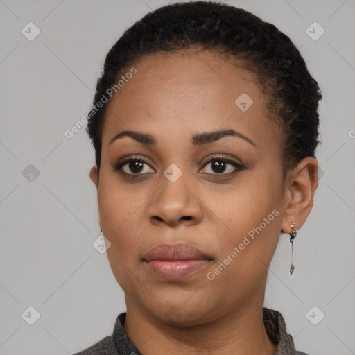 Joyful black young-adult female with short  black hair and brown eyes