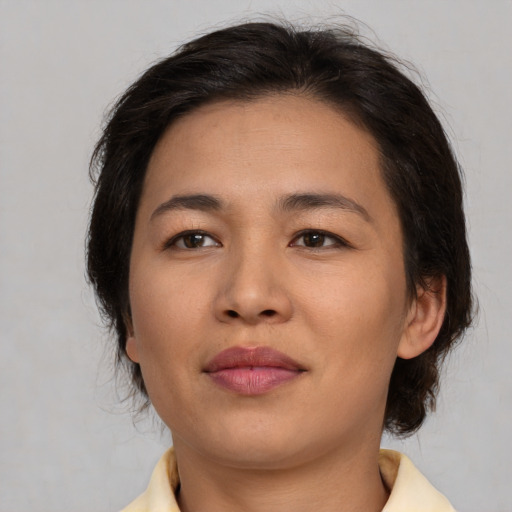 Joyful asian young-adult female with medium  brown hair and brown eyes