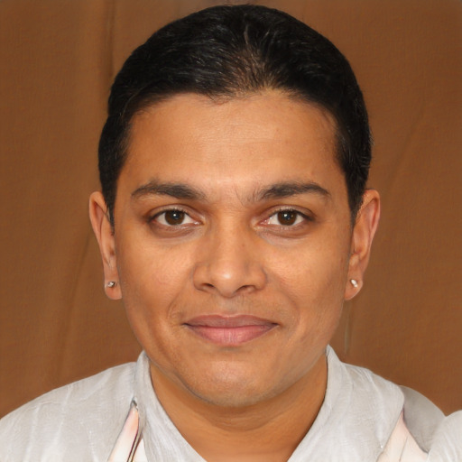 Joyful latino young-adult male with short  brown hair and brown eyes