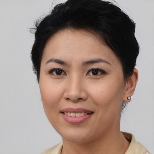 Joyful asian young-adult female with short  brown hair and brown eyes