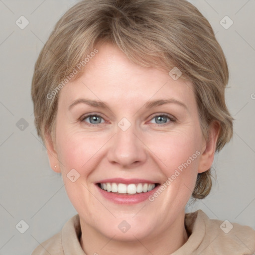 Joyful white adult female with medium  brown hair and blue eyes