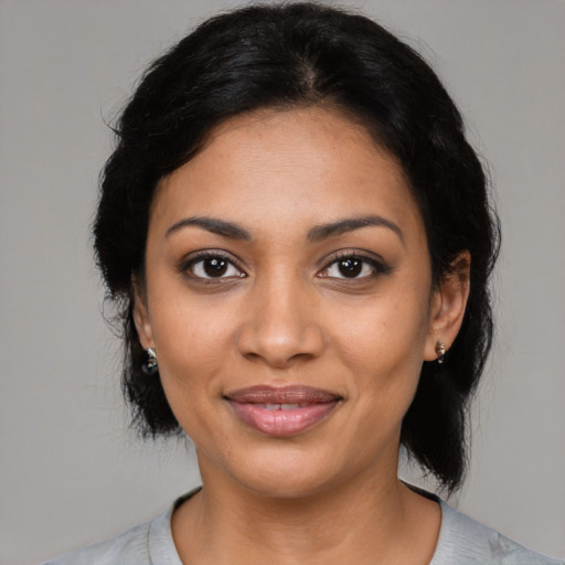 Joyful latino young-adult female with medium  black hair and brown eyes