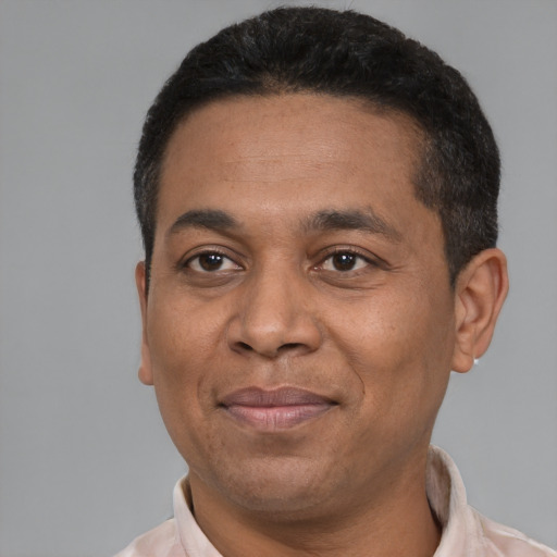 Joyful latino adult male with short  black hair and brown eyes