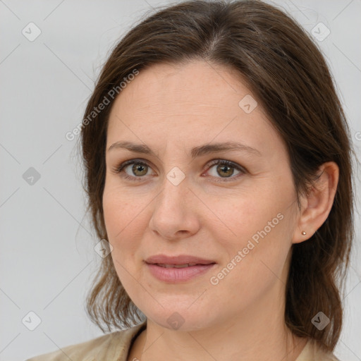 Joyful white adult female with medium  brown hair and brown eyes