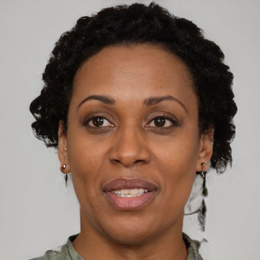 Joyful black adult female with short  brown hair and brown eyes