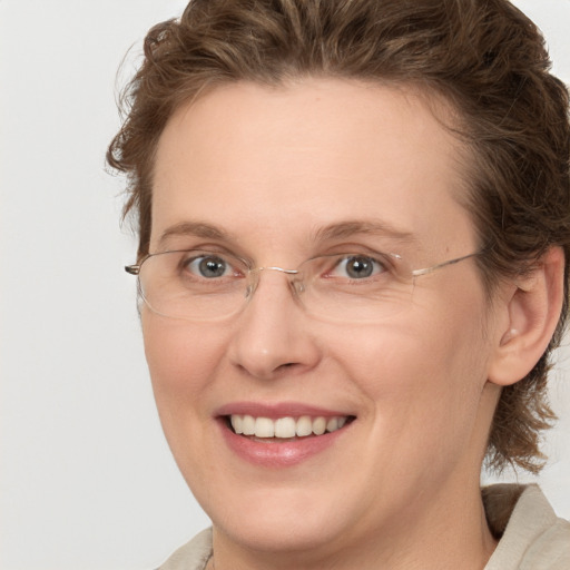 Joyful white adult female with medium  brown hair and green eyes