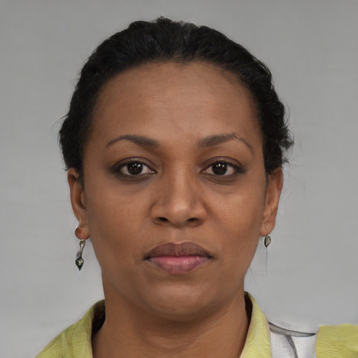 Joyful black adult female with short  brown hair and brown eyes