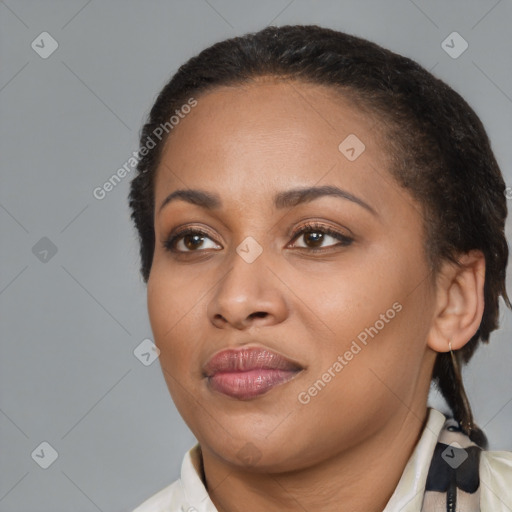 Joyful black adult female with medium  brown hair and brown eyes