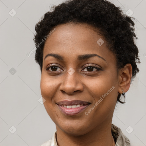 Joyful black young-adult female with short  brown hair and brown eyes