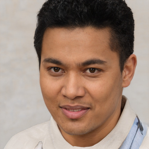 Joyful asian young-adult male with short  brown hair and brown eyes