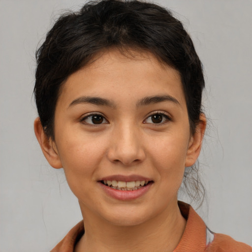 Joyful asian young-adult female with short  brown hair and brown eyes