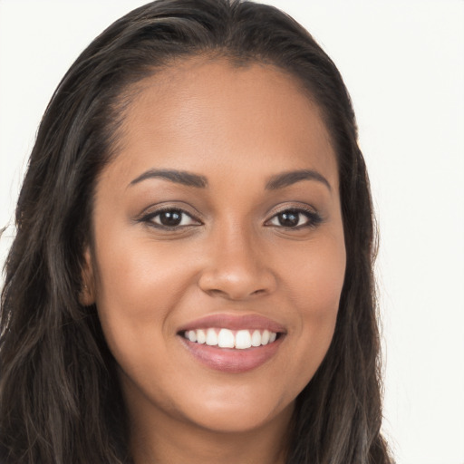 Joyful latino young-adult female with long  brown hair and brown eyes