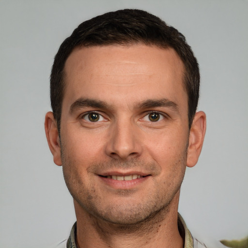 Joyful white young-adult male with short  brown hair and brown eyes