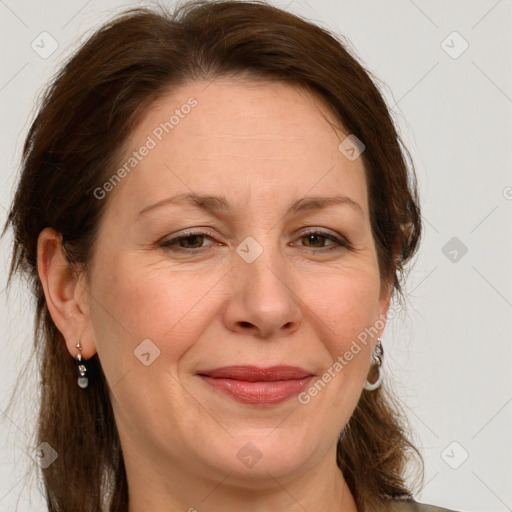 Joyful white adult female with long  brown hair and grey eyes