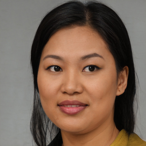Joyful asian young-adult female with long  black hair and brown eyes