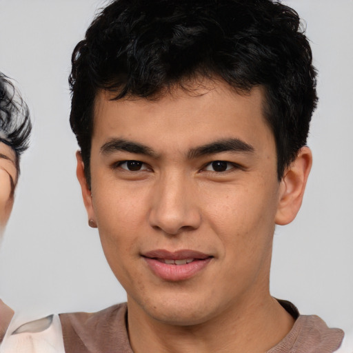 Joyful asian young-adult male with short  brown hair and brown eyes