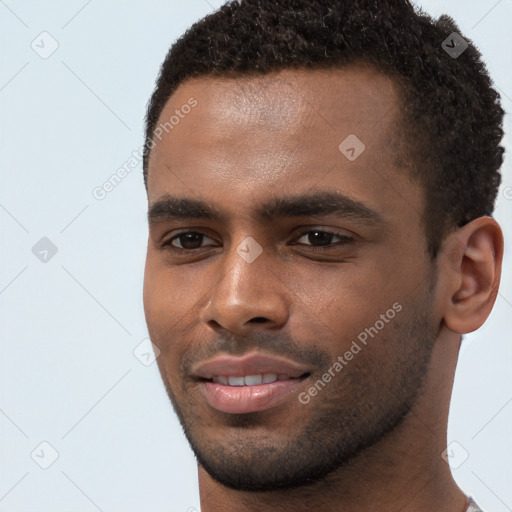 Joyful black young-adult male with short  brown hair and brown eyes