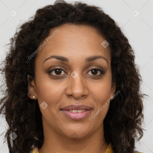 Joyful black young-adult female with long  brown hair and brown eyes