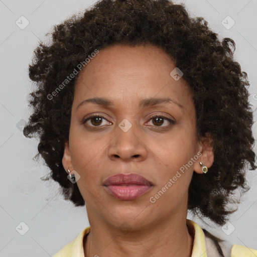 Joyful black adult female with medium  brown hair and brown eyes