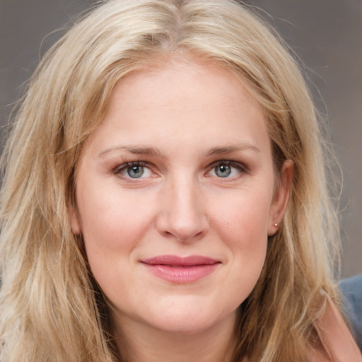 Joyful white young-adult female with long  brown hair and blue eyes