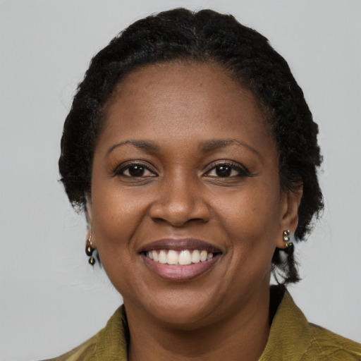 Joyful black adult female with long  brown hair and brown eyes