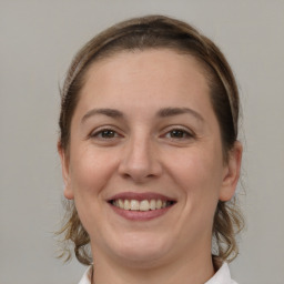 Joyful white young-adult female with medium  brown hair and brown eyes