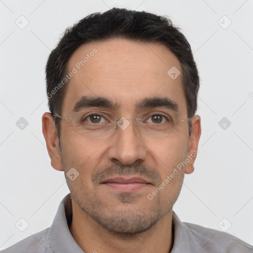 Joyful white adult male with short  black hair and brown eyes