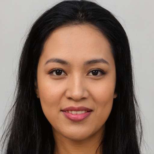 Joyful latino young-adult female with long  brown hair and brown eyes