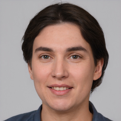 Joyful white young-adult male with medium  brown hair and brown eyes