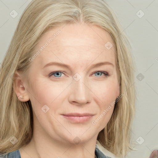 Joyful white adult female with medium  blond hair and blue eyes