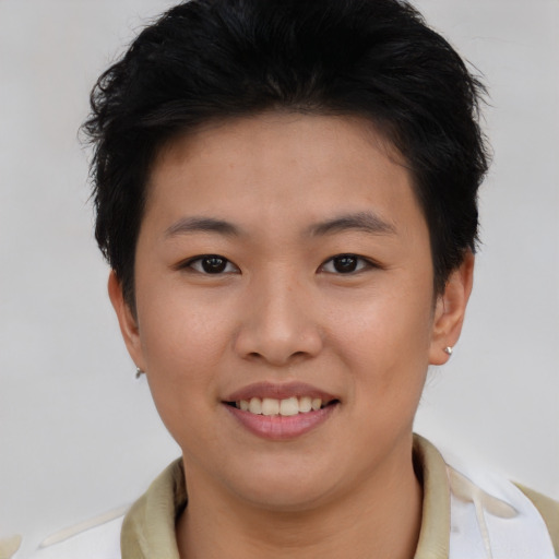 Joyful asian young-adult female with short  brown hair and brown eyes