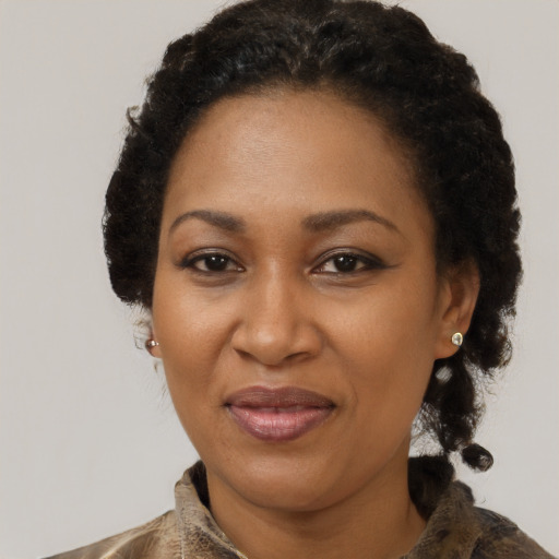 Joyful black adult female with short  brown hair and brown eyes