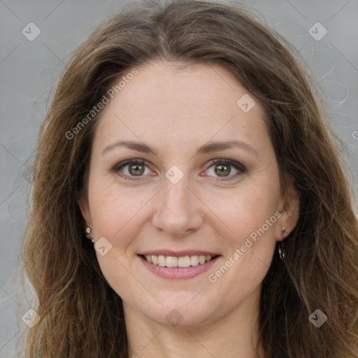 Joyful white adult female with long  brown hair and green eyes