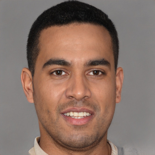 Joyful latino young-adult male with short  brown hair and brown eyes
