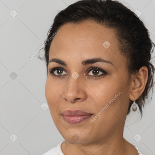 Joyful latino young-adult female with medium  brown hair and brown eyes