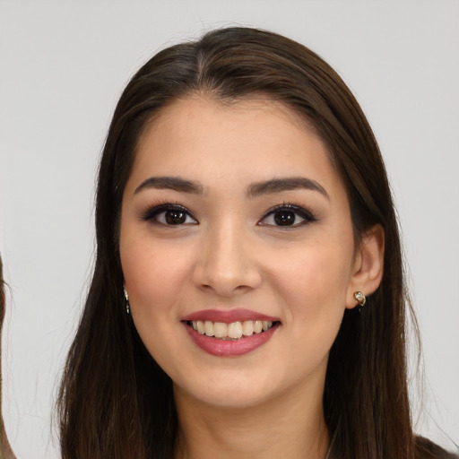 Joyful asian young-adult female with long  brown hair and brown eyes