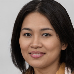 Joyful asian young-adult female with long  brown hair and brown eyes