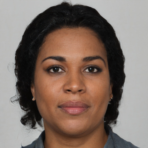 Joyful black young-adult female with medium  black hair and brown eyes
