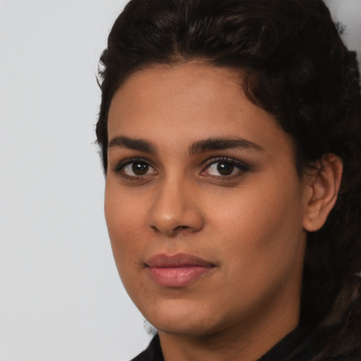 Joyful latino young-adult female with short  brown hair and brown eyes