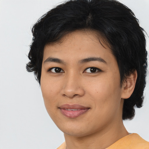 Joyful asian young-adult female with short  brown hair and brown eyes