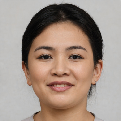 Joyful latino young-adult female with medium  black hair and brown eyes