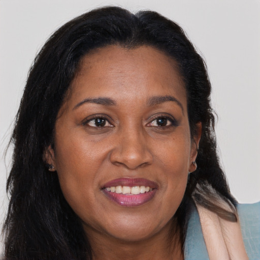 Joyful black young-adult female with long  brown hair and brown eyes