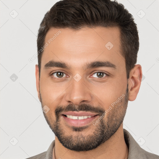 Joyful white young-adult male with short  brown hair and brown eyes